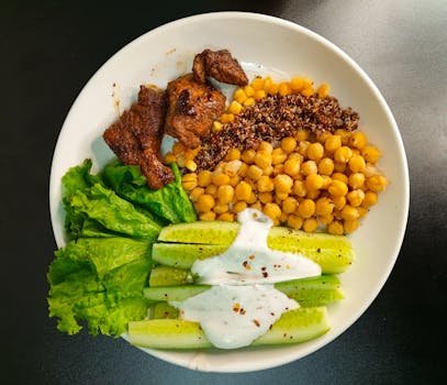 A nutritious bowl with quinoa, chickpeas, and fresh vegetables, perfect for a healthy meal.